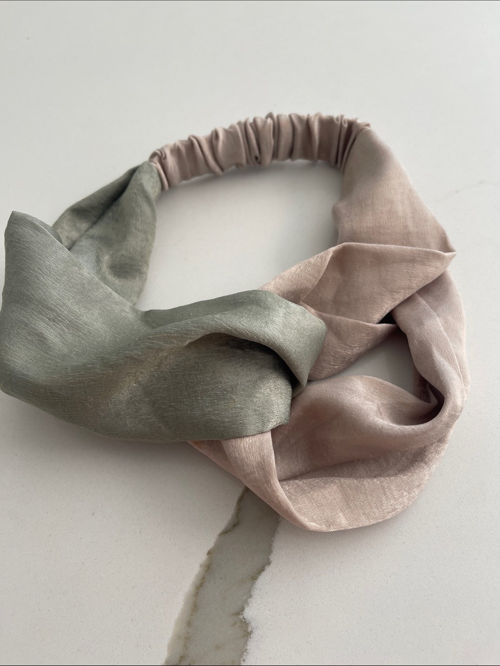 A Two-Tone Satin Twist Headband in Sage and Blush